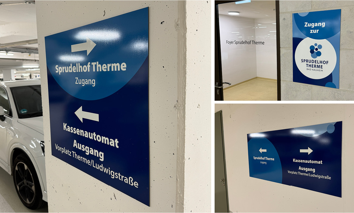 Kassenautomat und Wegweiser im Parkhaus der Sprudelhof Therme Bad Nauheim mit Beschilderung zu Ausgängen und Parkbereichen.